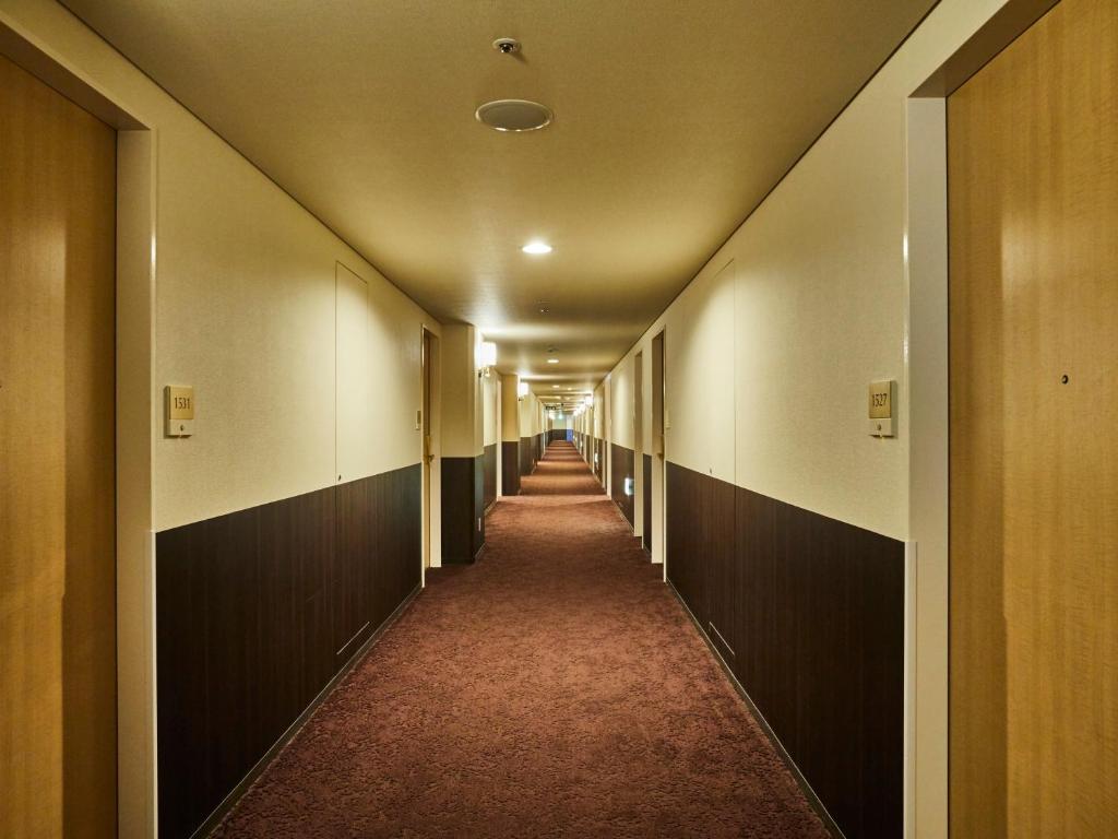 a hallway of an office building with a long corridor at Kansai Airport Washington Hotel in Izumi-Sano