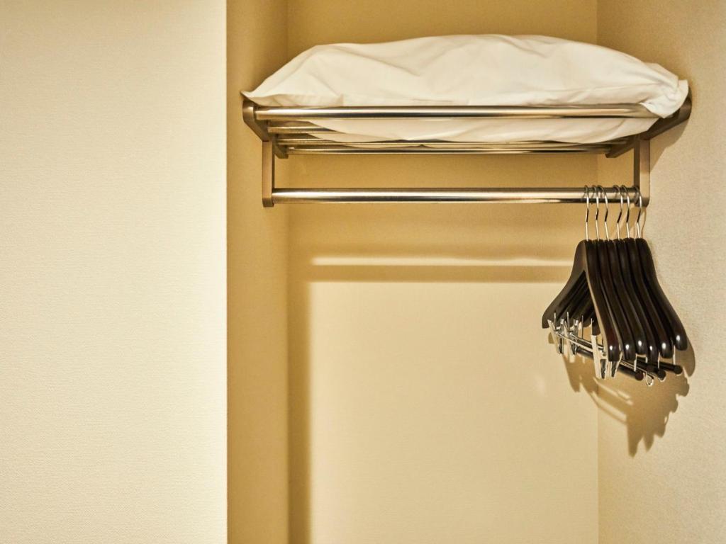 a towel rack with a bed in a room at Kansai Airport Washington Hotel in Izumi-Sano