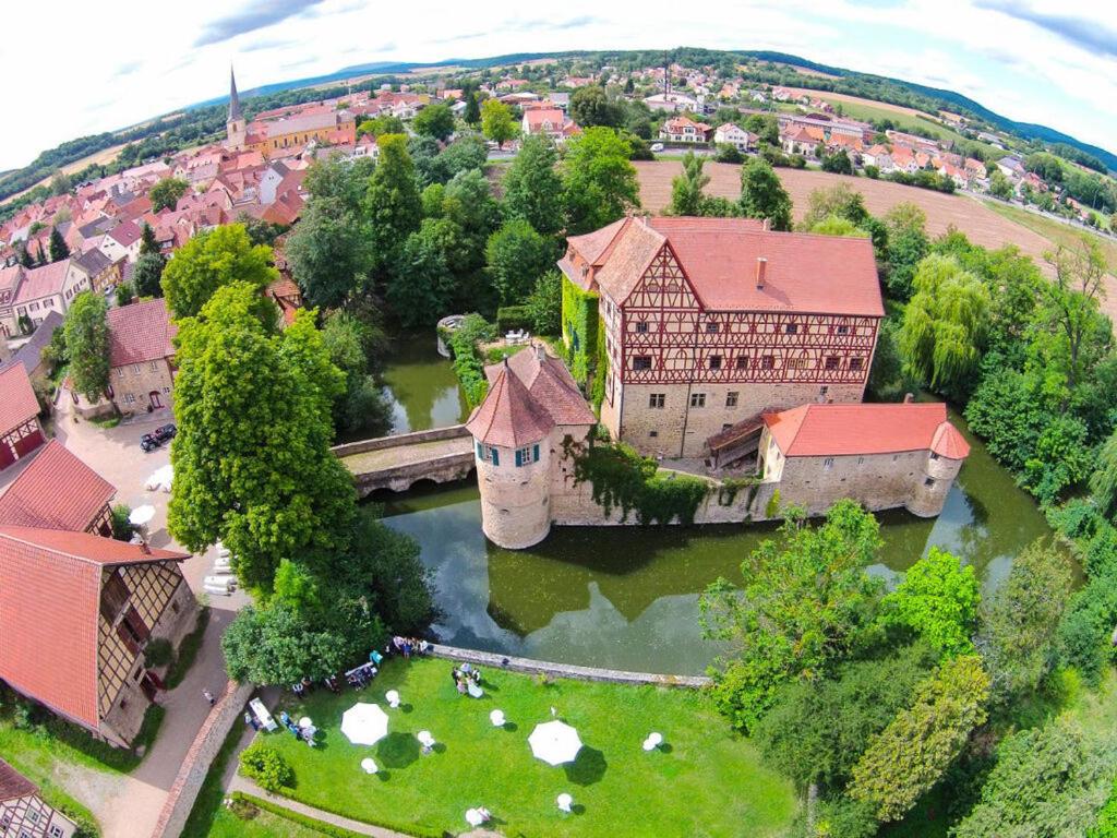 an aerial view of a building with a bridge over a river at Holiday home gardener's house in Unsleben