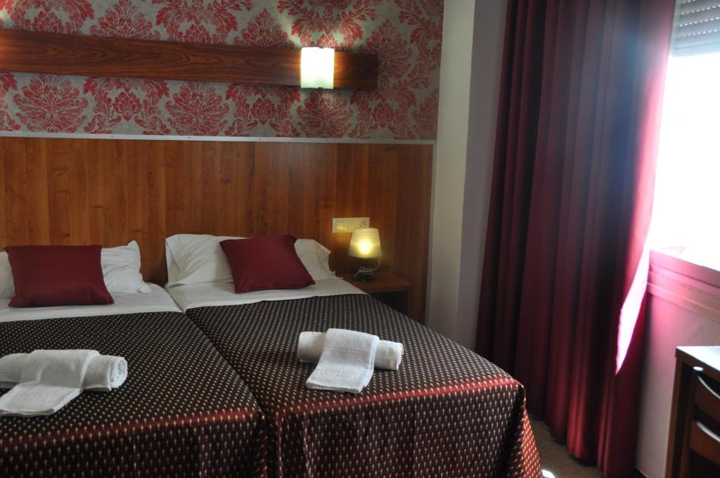 Postel nebo postele na pokoji v ubytování Hostal - Pensión El Amigo