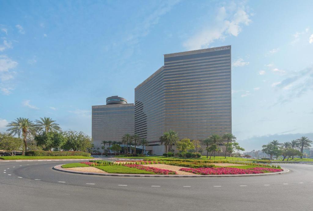 a large building with a circular road in front of it at Hyatt Regency Dubai - Corniche in Dubai