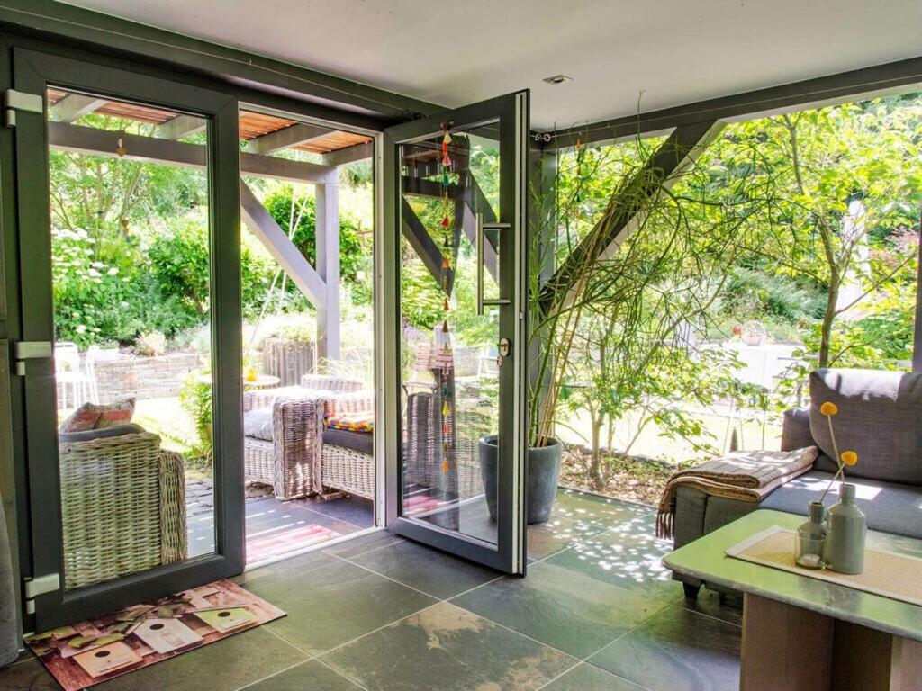 a conservatory with sliding glass doors leading to a patio at Romantic apartment with balcony 