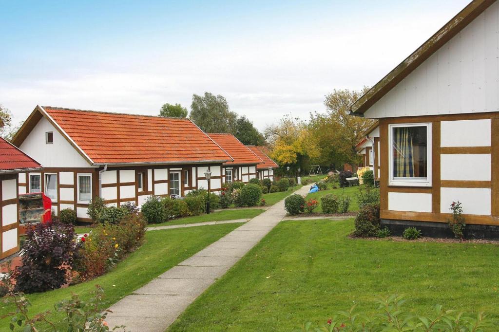 a row of houses in a yard with a driveway at Holiday village on the Baltic Sea Wohlenberg in Wohlenberg