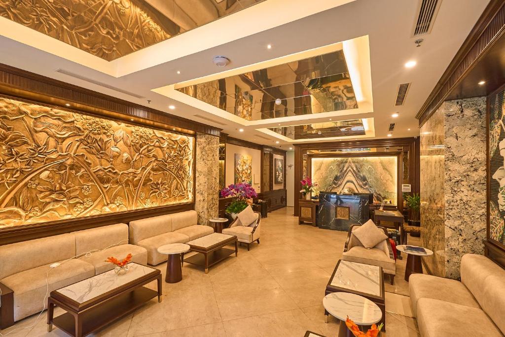 a lobby of a hotel with couches and a fireplace at Minasi Premium Hotel in Hanoi