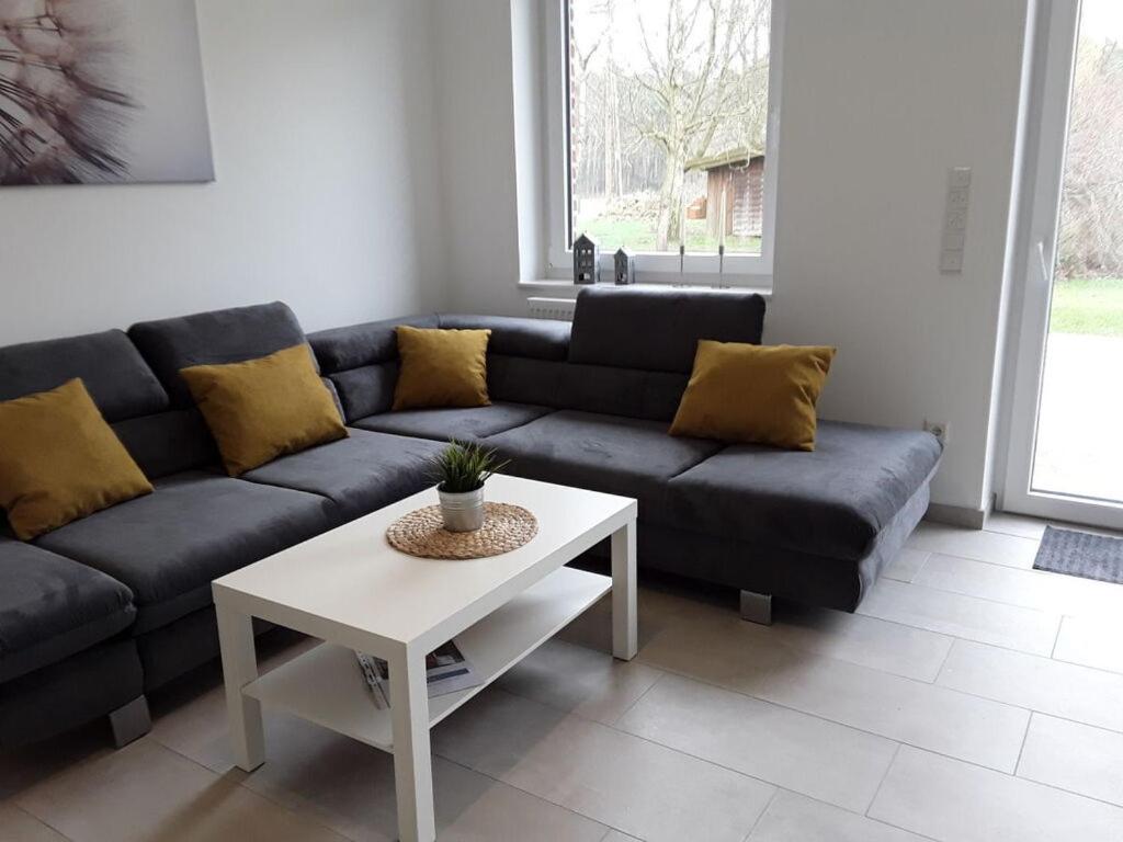 a living room with a couch and a table at Pleasant apartment in Ostbevern in Ostbevern