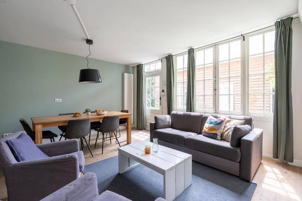 a living room with a couch and a table at Amsterdam Dockside Flats in Amsterdam