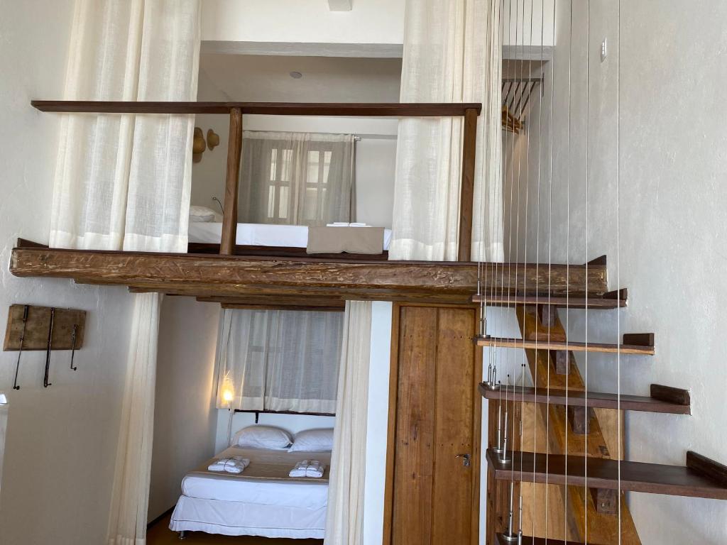 Postel nebo postele na pokoji v ubytování Casa Versace Salvador - Colonial House