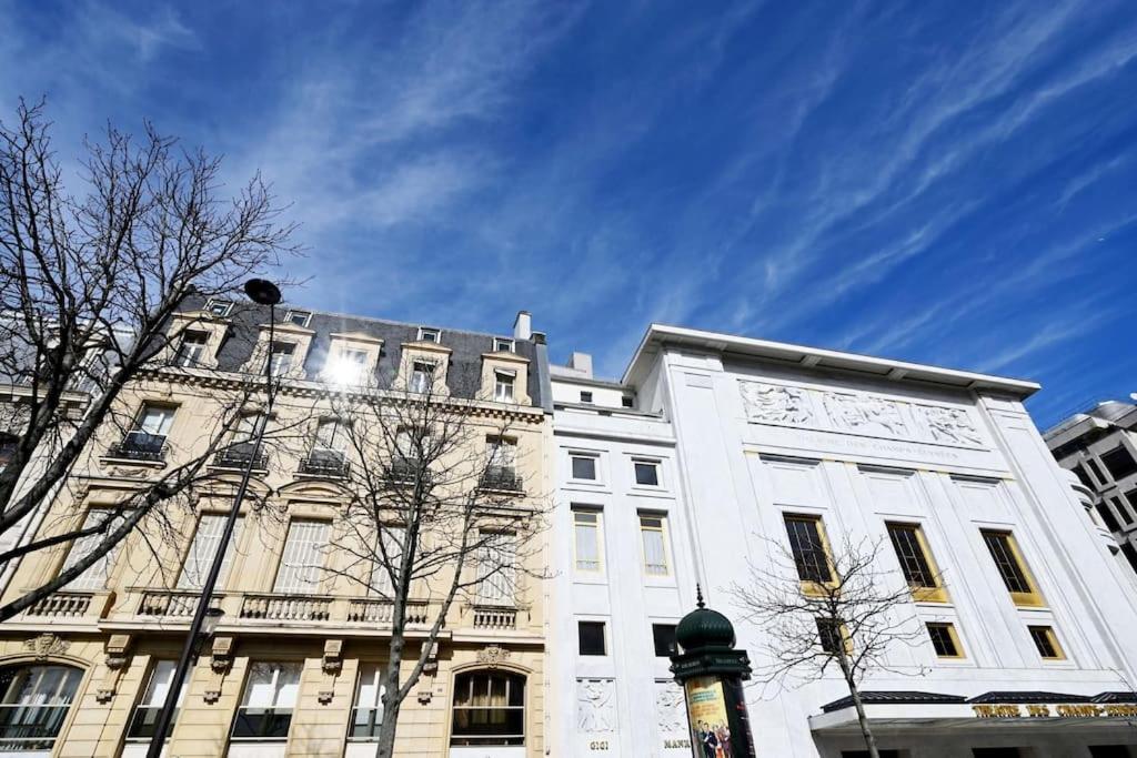 a large white building with a sky in the background at Elegant studio avenue Montaigne in Paris
