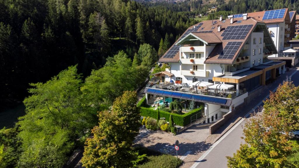 an aerial view of a house with solar panels on the roof at Hotel Erica in Tesero