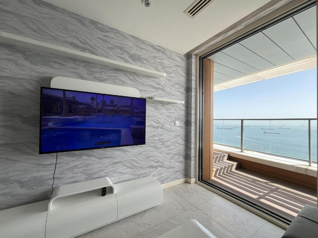 a living room with a flat screen tv on a wall at Marmara Magic: Jacuzzi Getaway in Istanbul