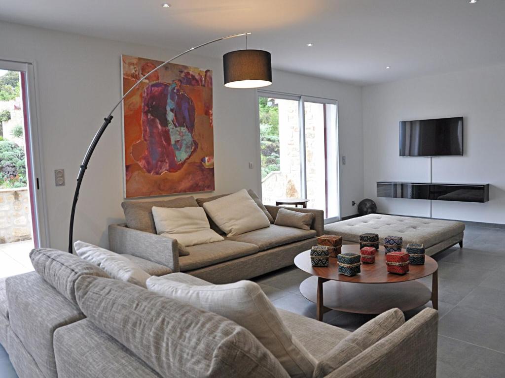 a living room with a couch and a table at Magnificent Villa in Saint Ambroix with Private Pool in Saint-Ambroix