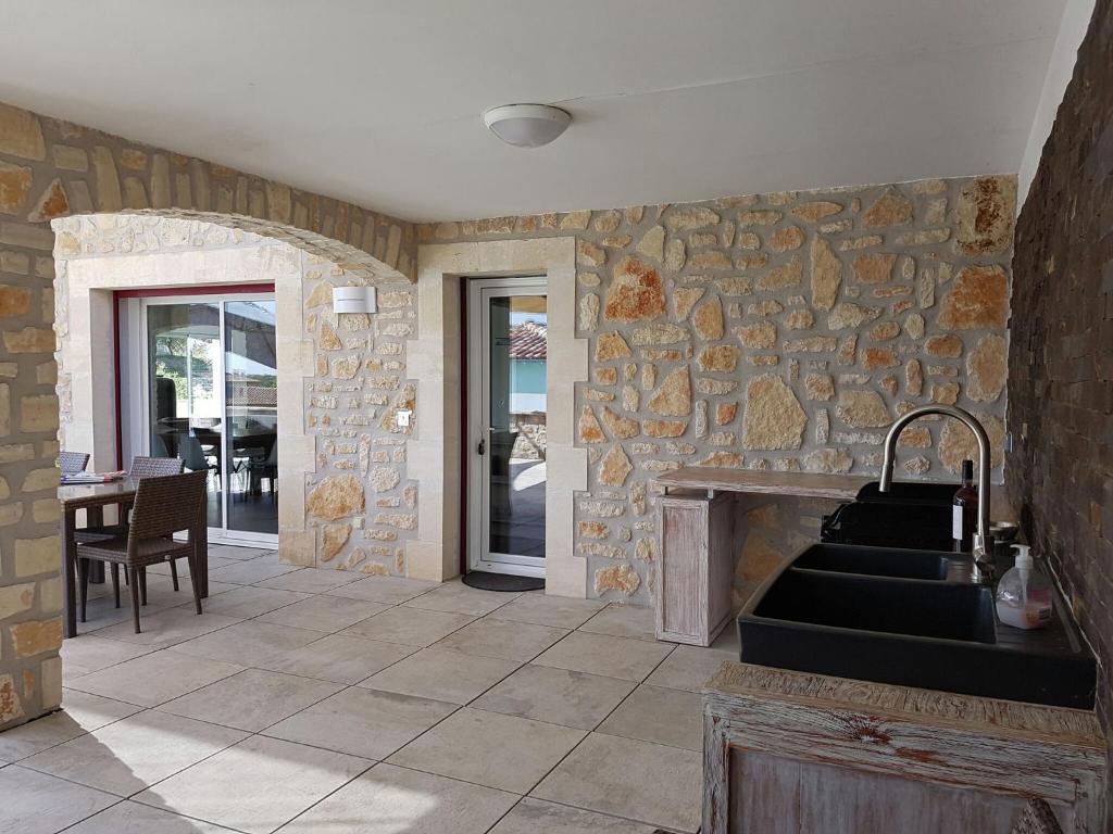 a kitchen with a stone wall and a sink at Magnificent Villa in Saint Ambroix with Private Pool in Saint-Ambroix