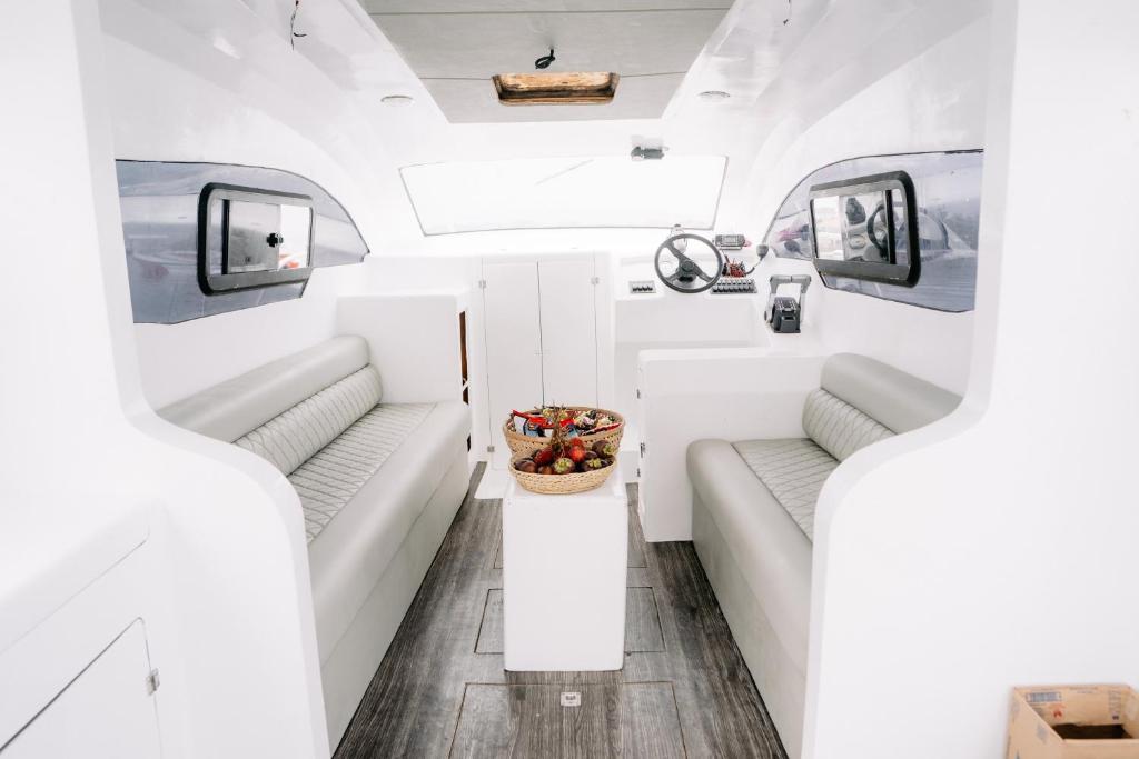 an interior view of a rv with two couches at Private Yacht Bali to Nusa Penida in Ujung