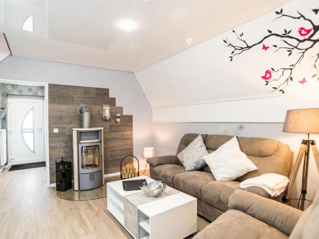 a living room with a couch and a table at Holiday home Villa Maiwaldo in Spieka-Neufeld