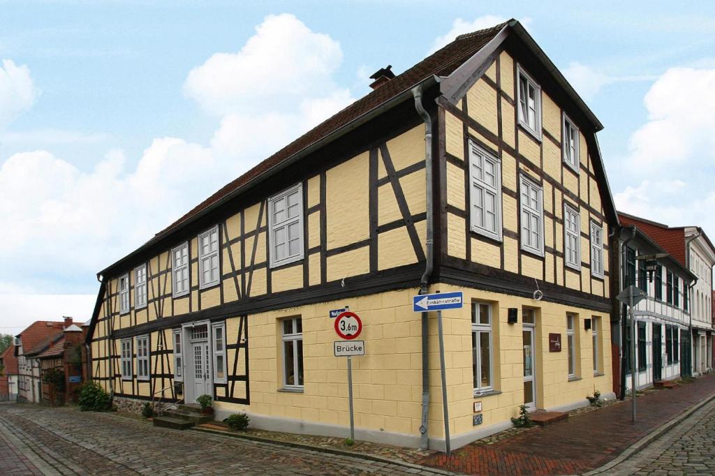 a yellow and black building on the side of a street at Apartment Plau am See in Plau am See