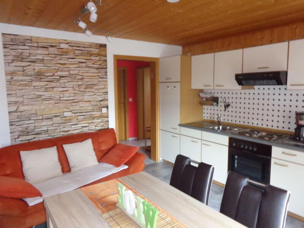 a kitchen and a living room with a couch and a table at Holiday apartment Haus Christa with balcony in Waldmünchen