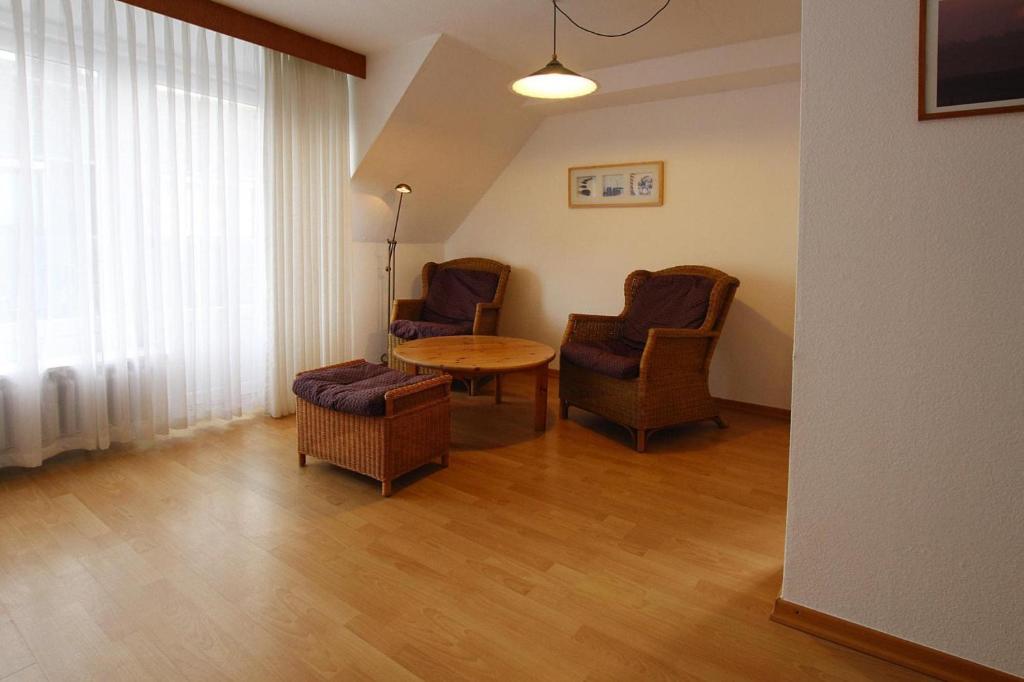 a living room with two chairs and a table at Apartment in Westerland in Westerland (Sylt)