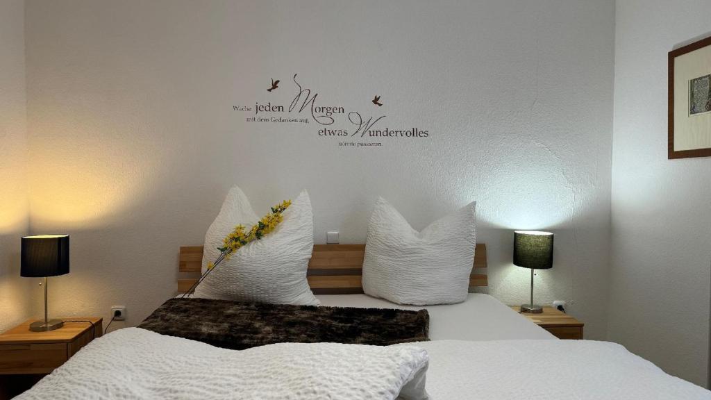 a bedroom with a bed with white sheets and white pillows at Ferienhaus Alexandra in Thyrnau in Thyrnau