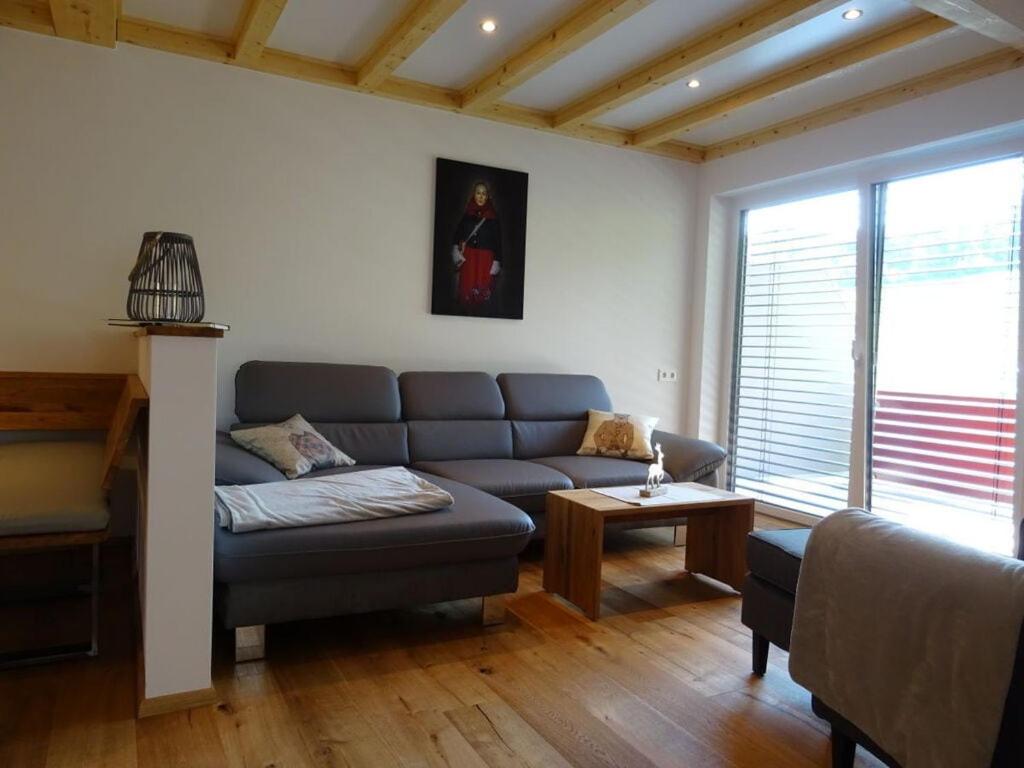 a living room with a couch and a table at Holiday apartment Beerewieble in Unterkirnach