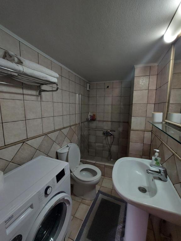 a bathroom with a washing machine and a sink at Μεζονέτα Αιγαίο in Chios