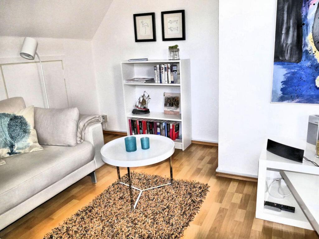 a living room with a couch and a table at Holiday apartment Green House in Aumühle