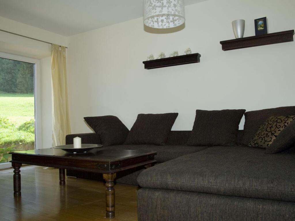 a living room with a couch and a coffee table at Holiday apartment Diana in Oberstaufen