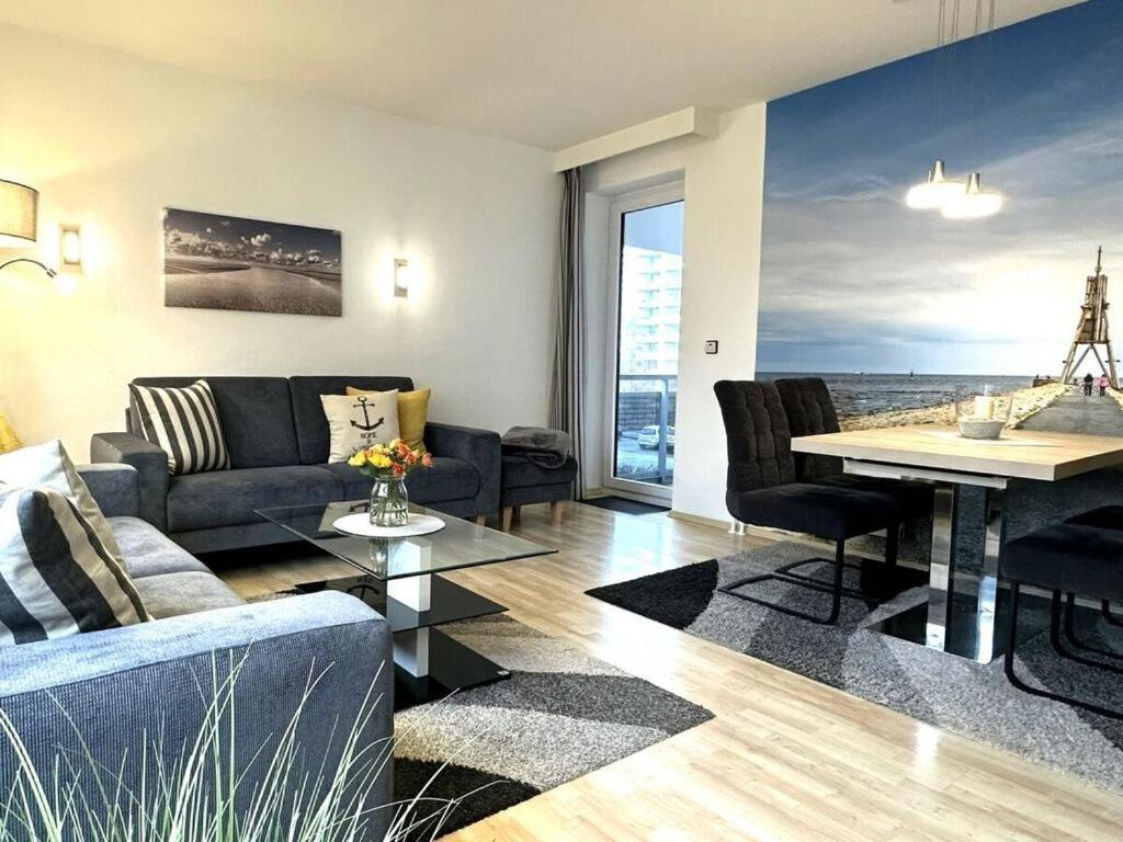 a living room with a couch and a table at Nice apartment near beach in Cuxhaven