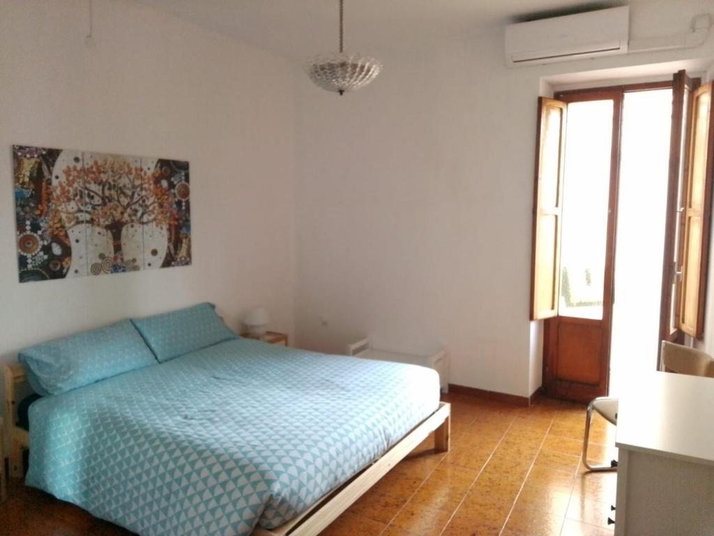 a bedroom with a bed and a painting on the wall at casa vacanza Sulmona centro in Sulmona