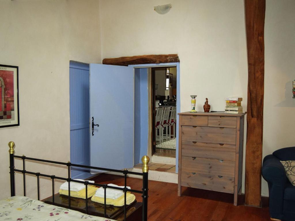 a bedroom with a bed and a dresser and a closet at Snug cottage in Saint Eutrope De Born with pool in Saint-Eutrope-de-Born