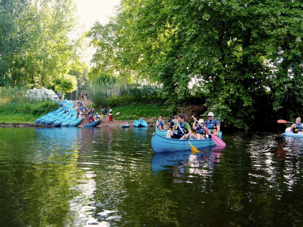 a group of people kayaking down a river in canoes at Snug cottage in Saint Eutrope De Born with pool in Saint-Eutrope-de-Born