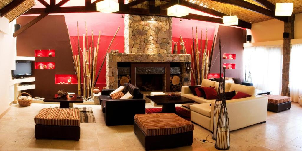 a living room with couches and a fireplace at Posada Con Los Ángeles in Tilcara