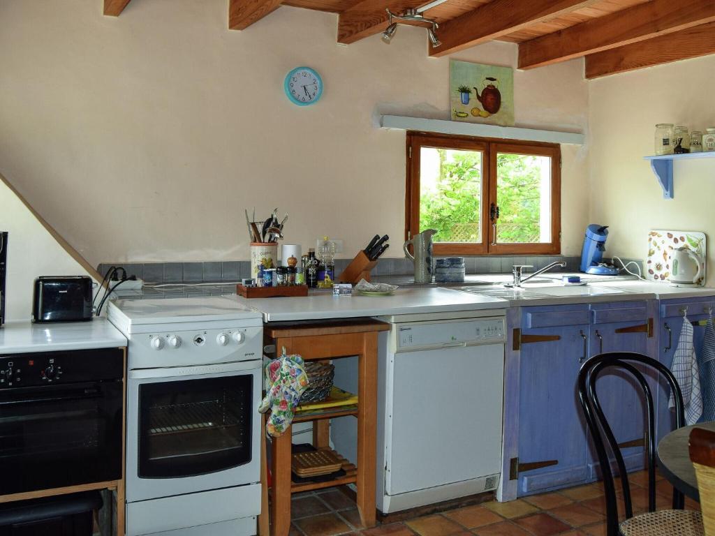 a kitchen with a stove and a sink at Snug cottage in Saint Eutrope De Born with pool in Saint-Eutrope-de-Born