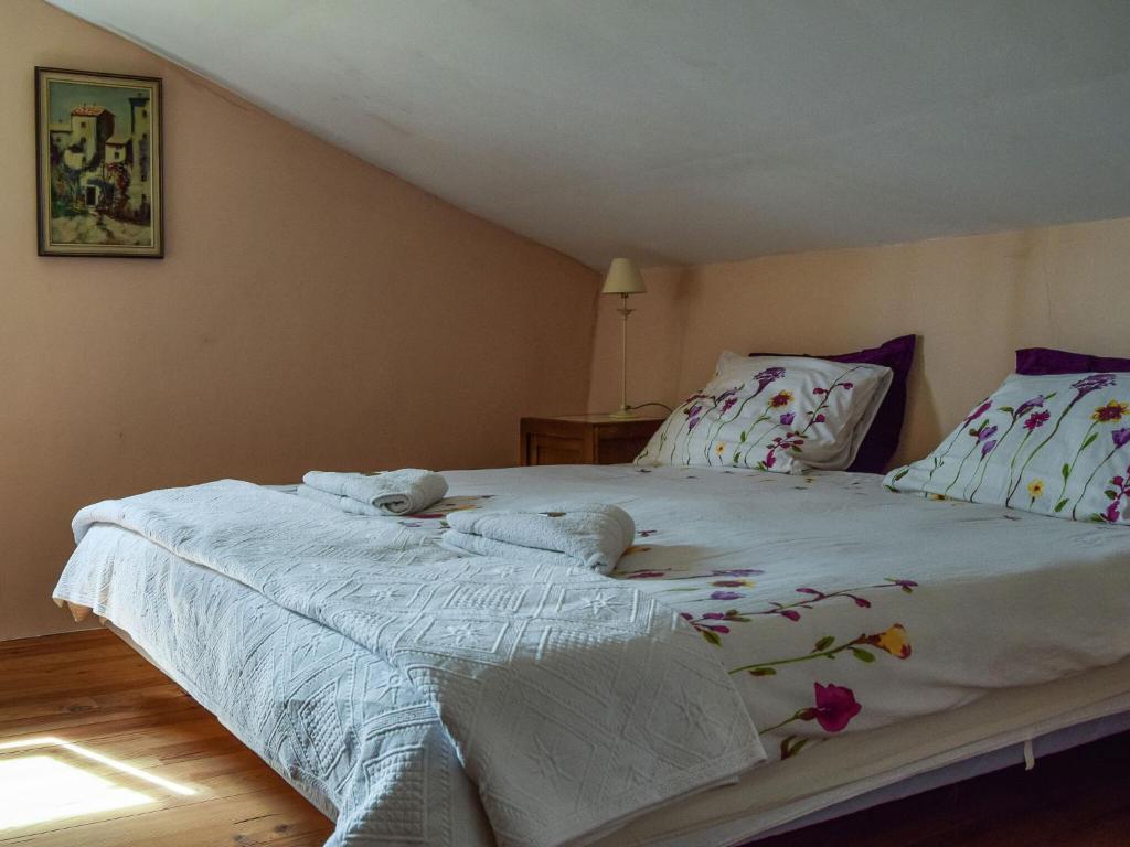 a bedroom with a bed with stuffed animals on it at Snug cottage in Saint Eutrope De Born with pool in Saint-Eutrope-de-Born