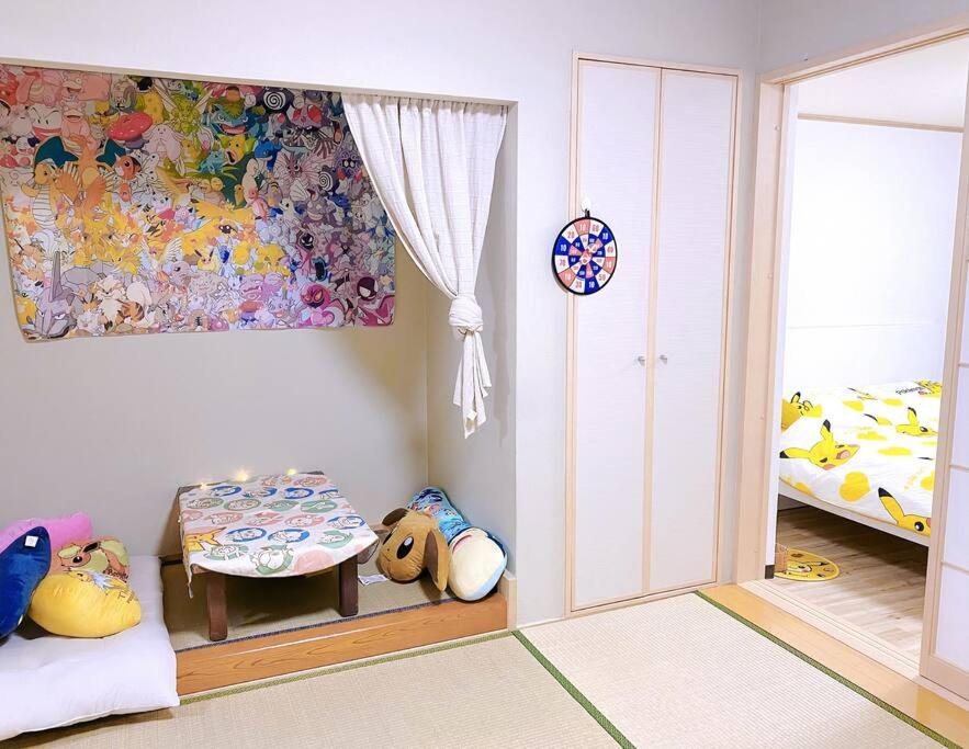 a childs room with a table and a bed at Pokémon Sleep 宝可梦的家 in Osaka