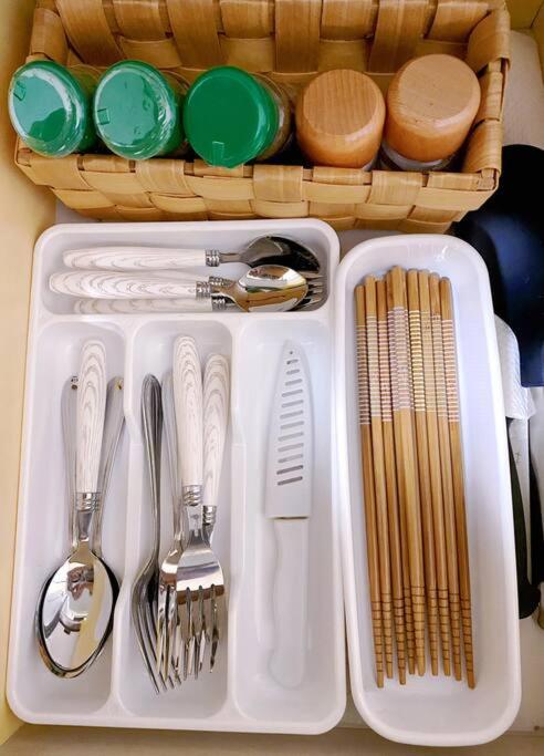 a white tray with utensils and a basket of dishes at Pokémon Sleep 宝可梦的家 in Osaka