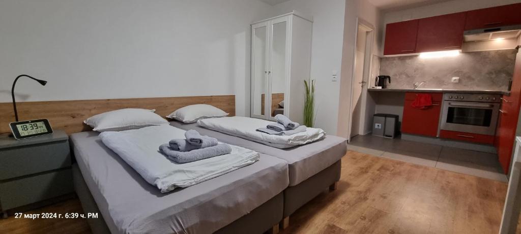 a bedroom with two beds with towels on them at Studio Apartment Nähe S-Bahn in Oberesslingen