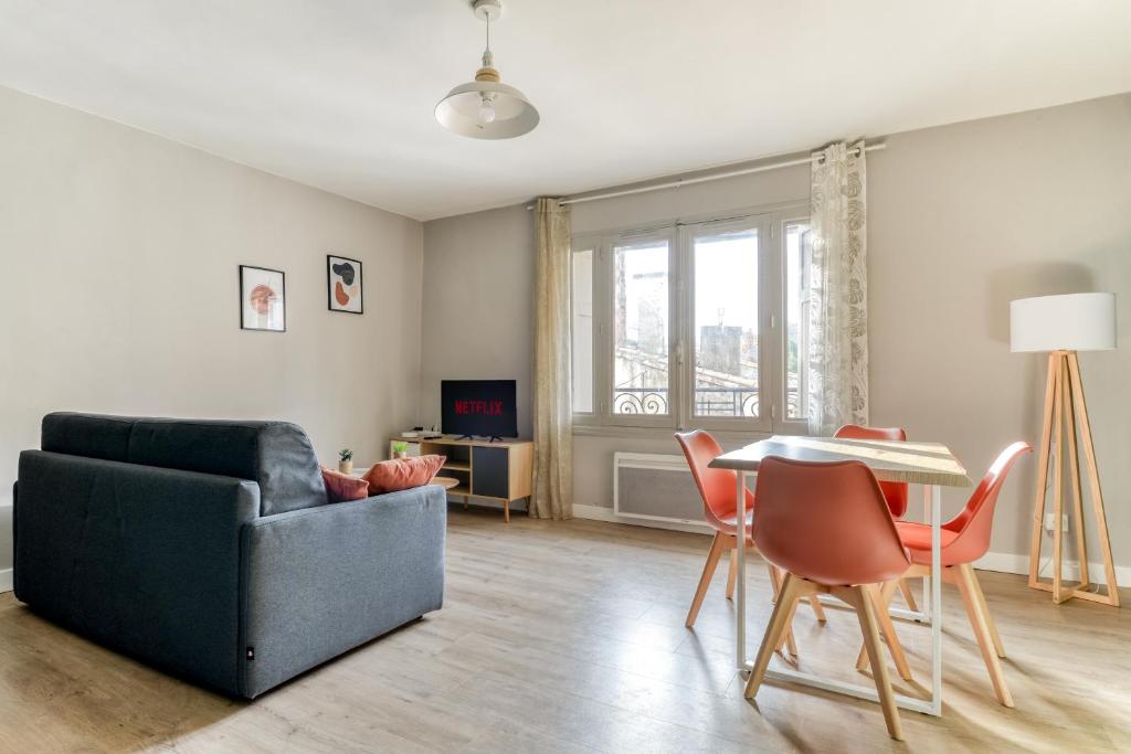 un salon avec un canapé, une table et des chaises dans l'établissement L'Émeraude de la Cité - Netflix - Fibre - Proche Cité - Clim, à Carcassonne