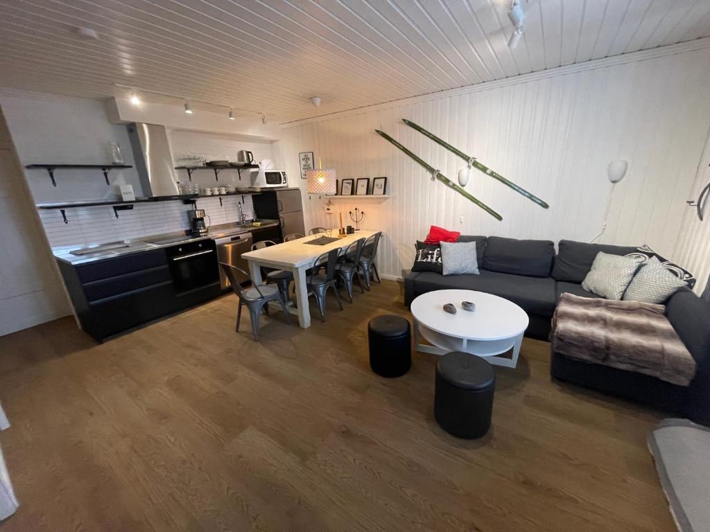 a living room with a couch and a table at Brostigen 5, Vemdalsskalet in Vemdalen