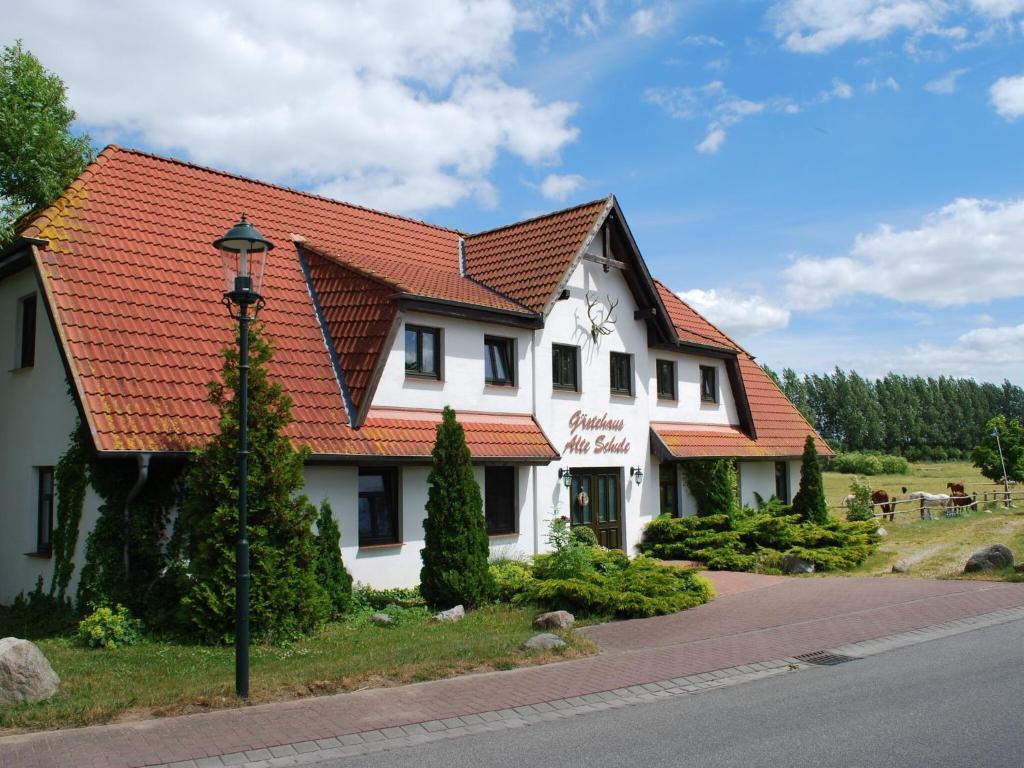 a white building with an orange roof at Comfortable apartment in quaint holiday village in Barlin
