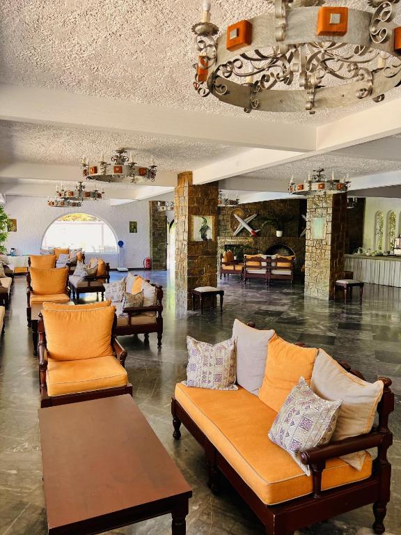 a lobby with couches and chairs in a room at Karteros Hotel in Karteros
