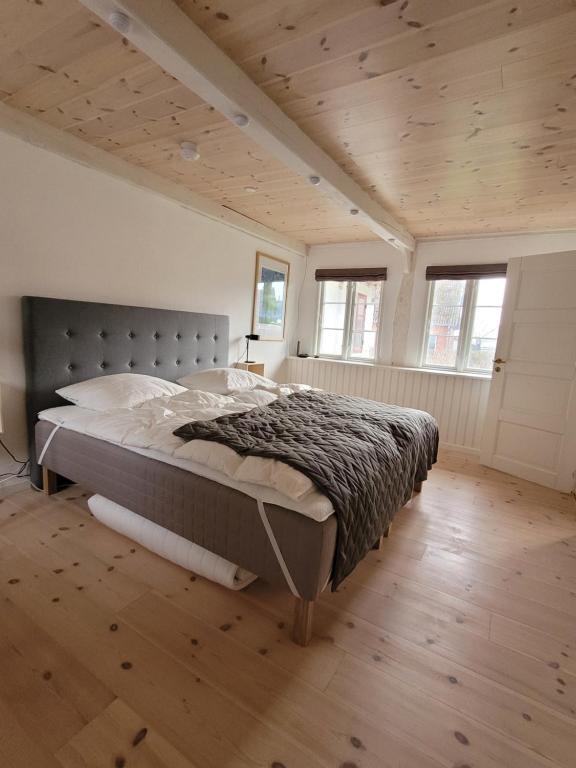 Nyord的住宿－Ragnhilds Gård, Hostel，铺有木地板的客房设有一间带大床的卧室