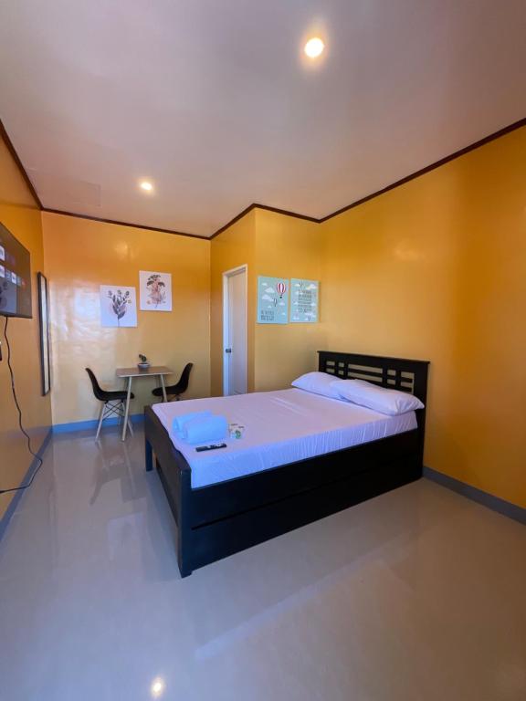 a bedroom with a large bed and a table at Halajo bnb transient in Laoag