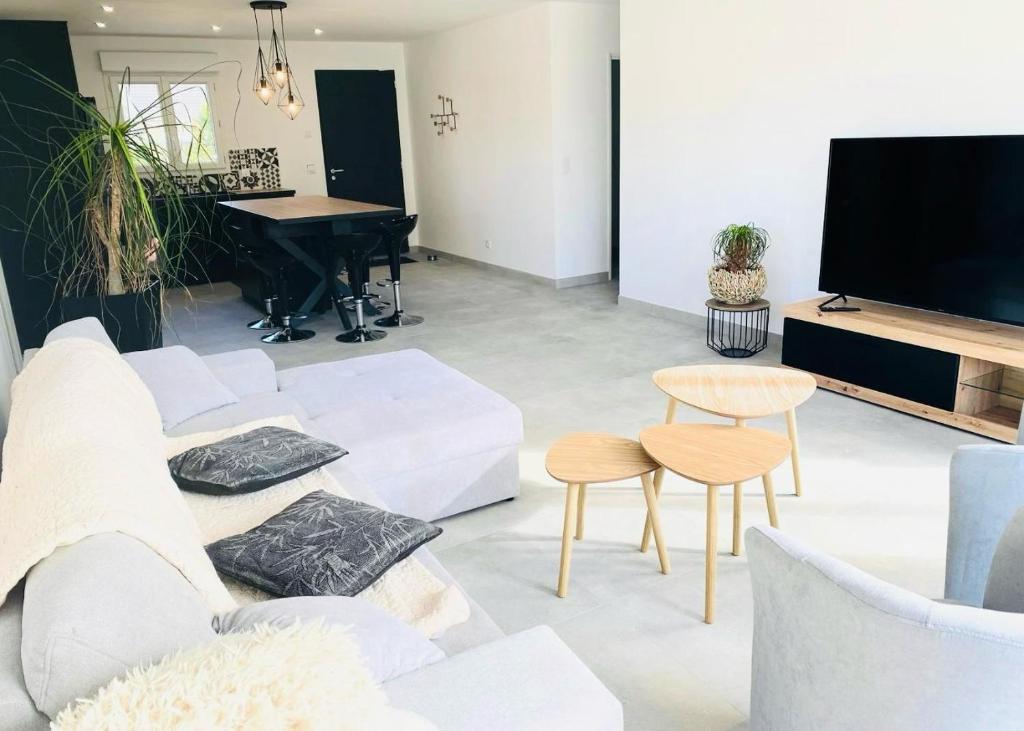 sala de estar con sofá blanco y piano en Maison 10 couchages en Romorantin