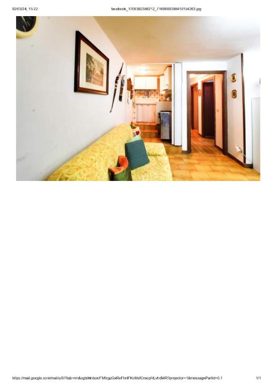 a living room with a yellow couch in a room at Casa Alamancheva in Martinsicuro