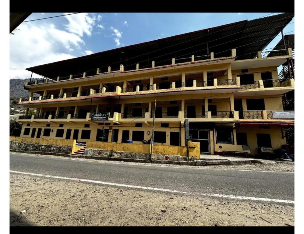 a large building on the side of a road at Anu Shree Lodge, Ukhimath in Ukhimath