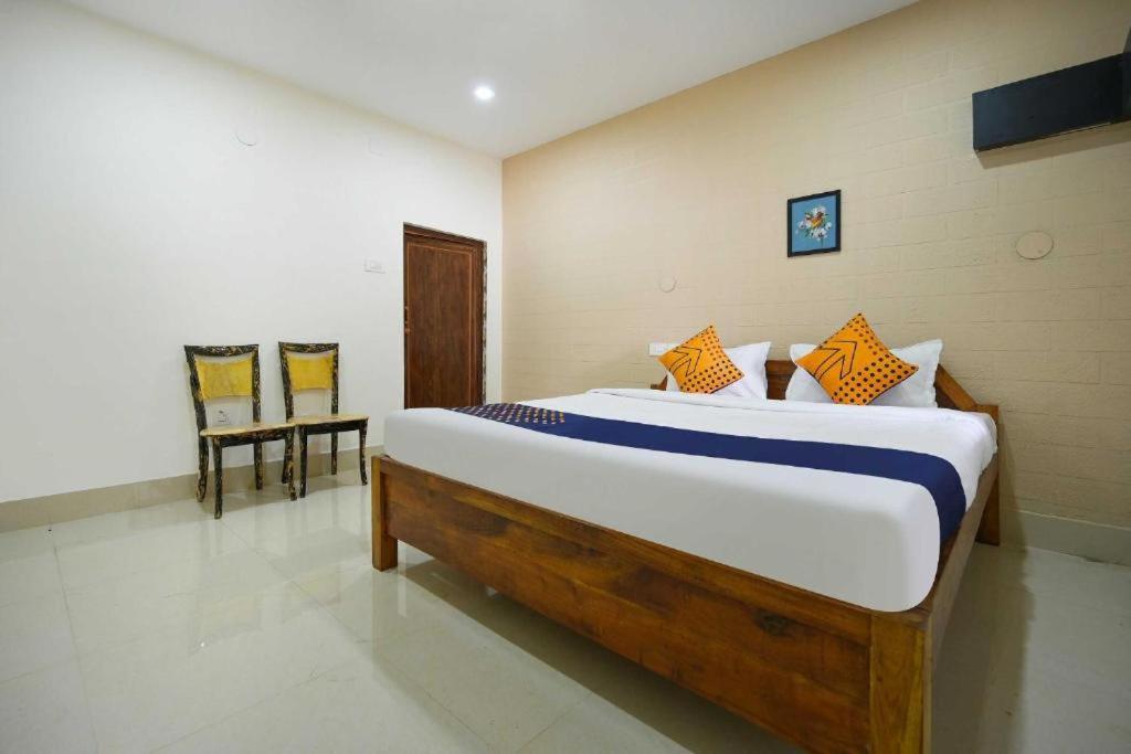 ニューデリーにあるHotel Moody Moon budget friendly stay near igi international airport delhiのベッドルーム1室(大型ベッド1台、椅子2脚付)