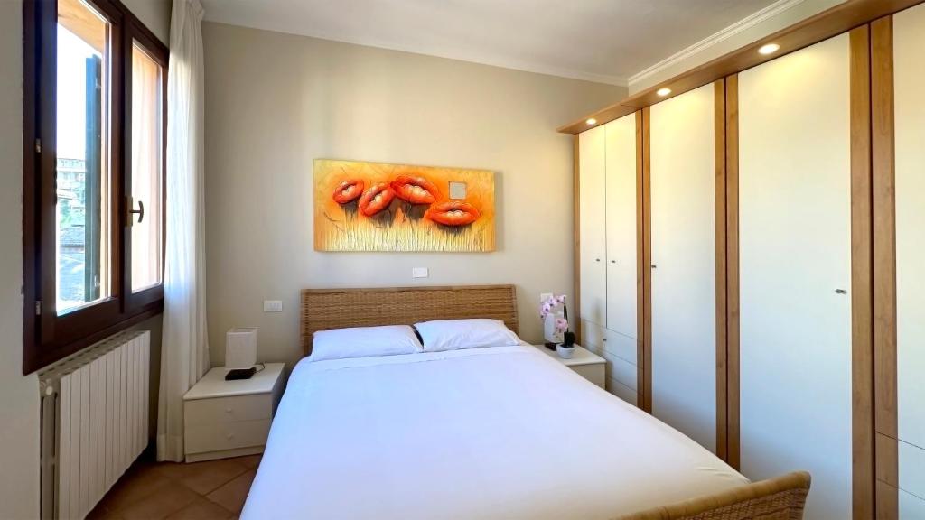 a bedroom with a bed and a painting of tomatoes at Int 11 - Appartamento Elisa in Bologna