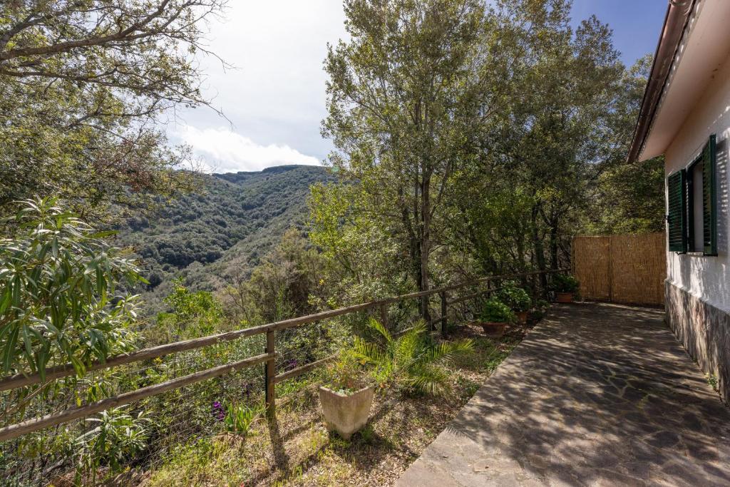 a house with a balcony with a view of the mountains at Villino Straccoligno - Goelba in Capoliveri