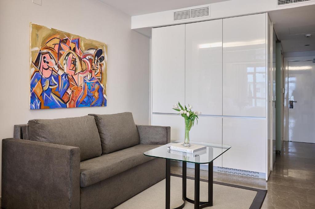 a living room with a couch and a table at VP Madroño in Madrid