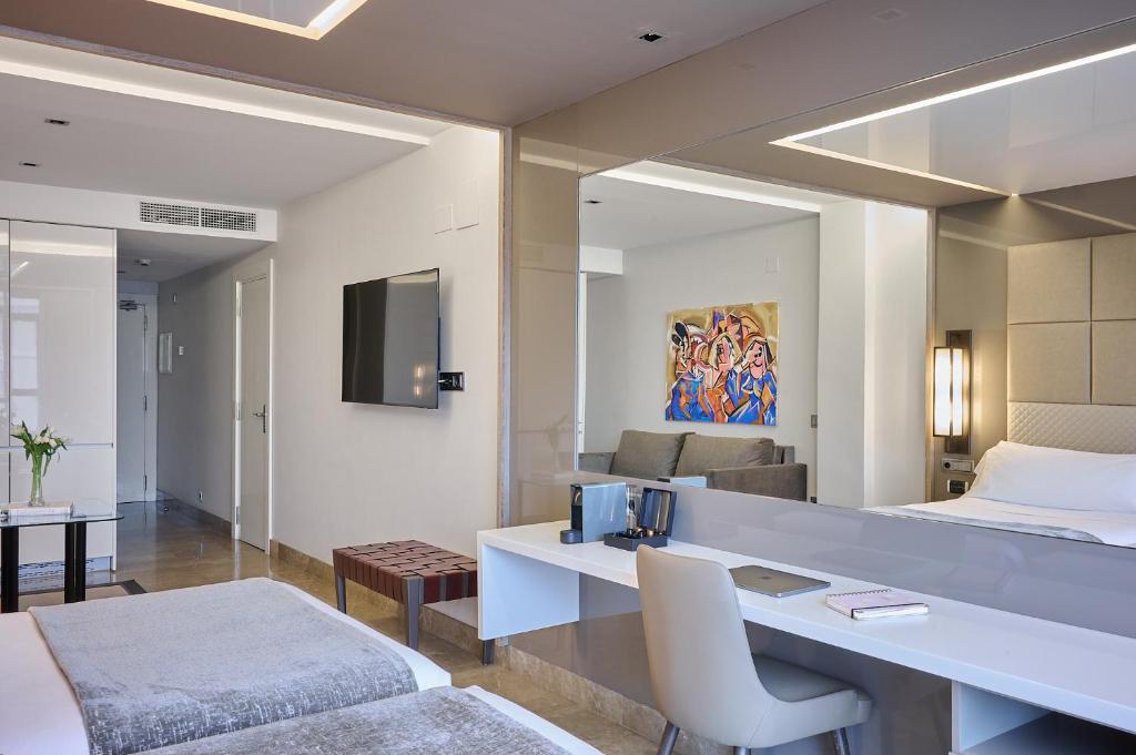 a hotel room with a bed and a desk at VP Madroño in Madrid